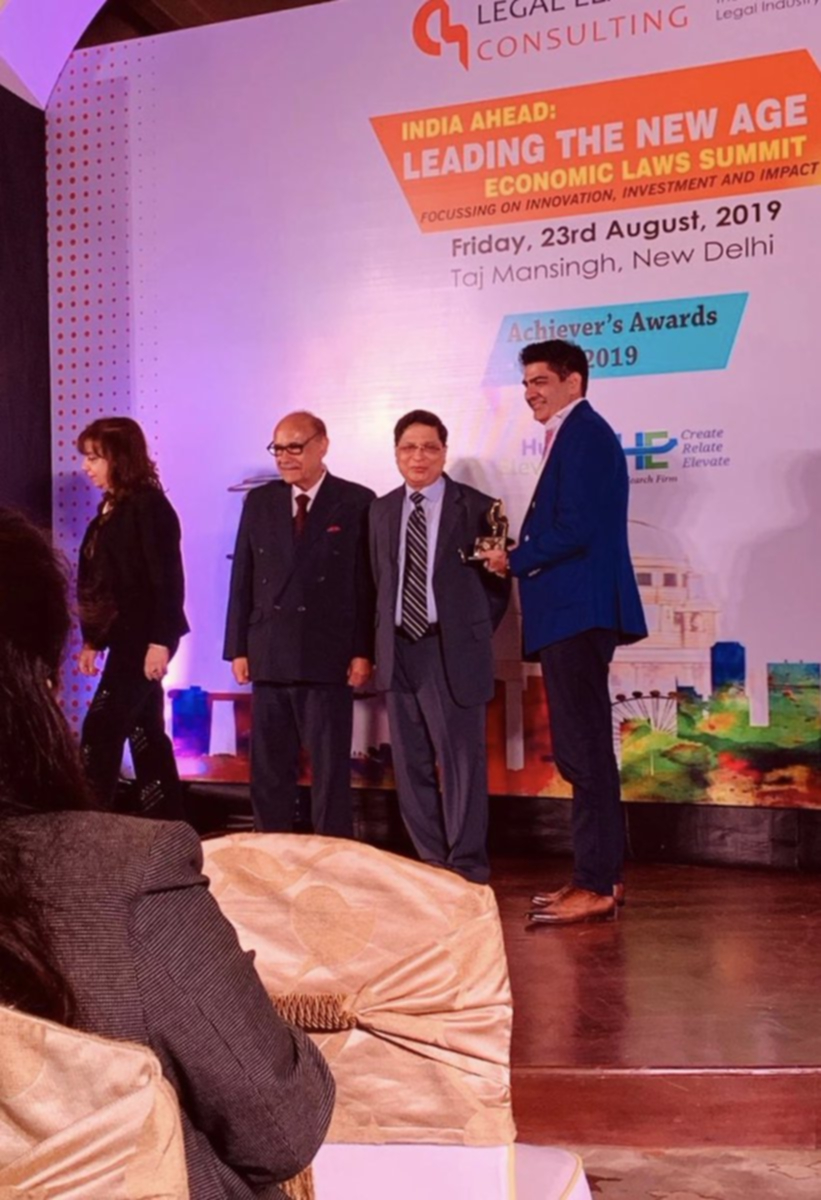 Safir Anand receiving award for Sterling Performance in Business and Law from Legal League Consulting